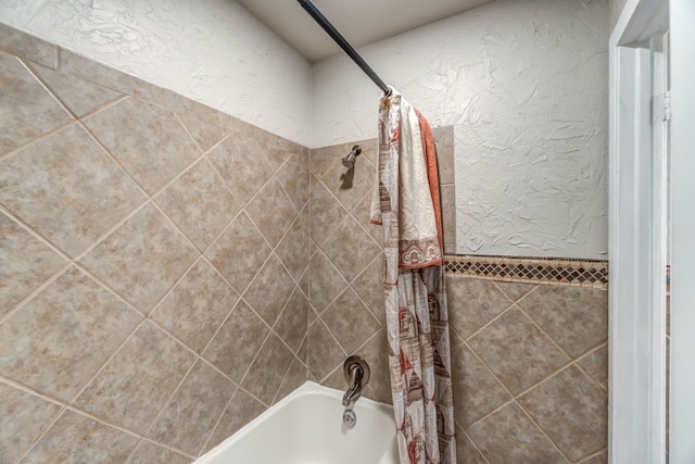 bathroom with shower / bathtub combination with curtain