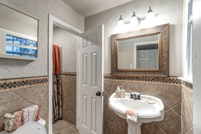 bathroom with tile walls