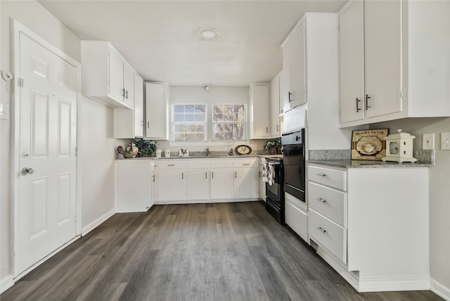 kitchen featuring light stone countertops, black electric range, sink, white cabinets, and dark hardwood / wood-style floors