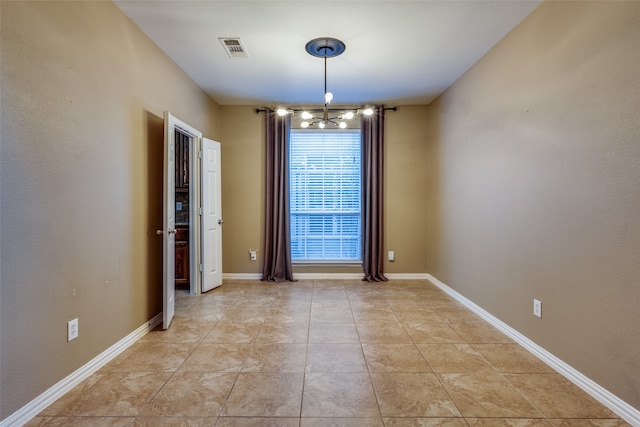 unfurnished dining area featuring light tile patterned flooring and an inviting chandelier