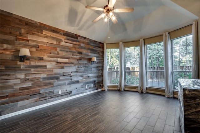 unfurnished sunroom featuring ceiling fan