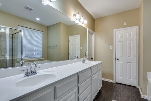 bathroom with hardwood / wood-style floors, vanity, and independent shower and bath