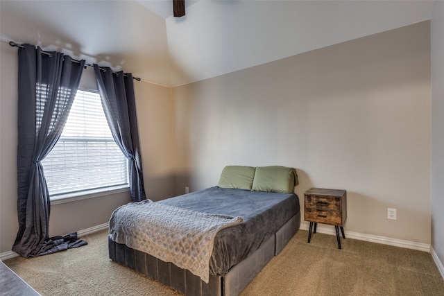 bedroom with carpet flooring and lofted ceiling