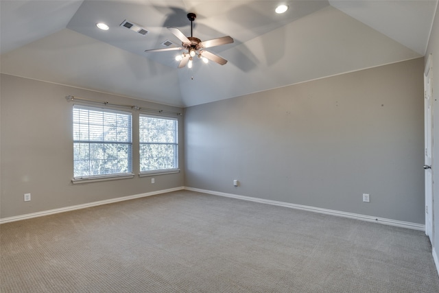 spare room featuring carpet flooring, ceiling fan, and lofted ceiling