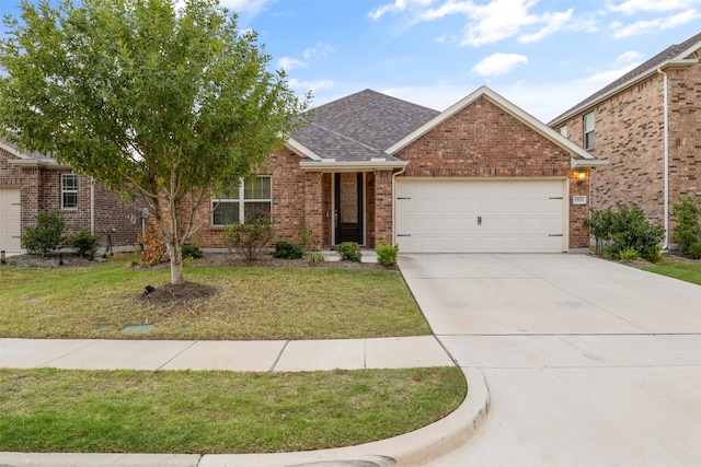 view of front of home featuring a front lawn and a garage