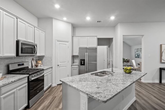 kitchen featuring a center island with sink, sink, and appliances with stainless steel finishes