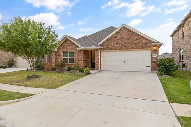 view of front facade with a garage and a front lawn