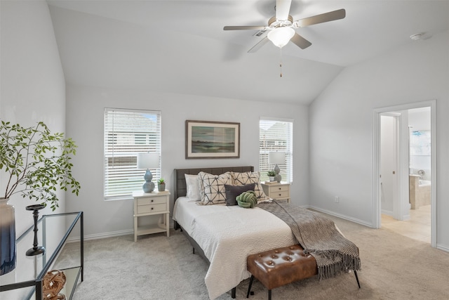 bedroom with ensuite bathroom, lofted ceiling, light colored carpet, and ceiling fan