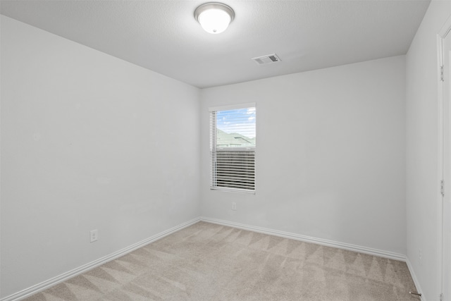 spare room with light colored carpet