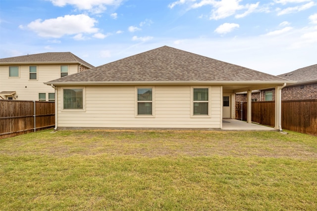 rear view of property featuring a patio area and a lawn