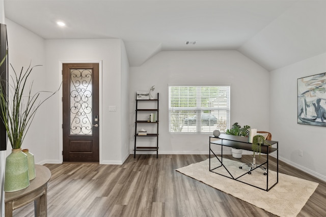 home office with lofted ceiling and wood-type flooring