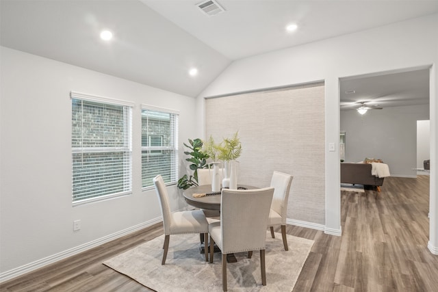 dining room with ceiling fan, lofted ceiling, and hardwood / wood-style floors