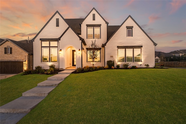 view of front facade with a yard and a garage