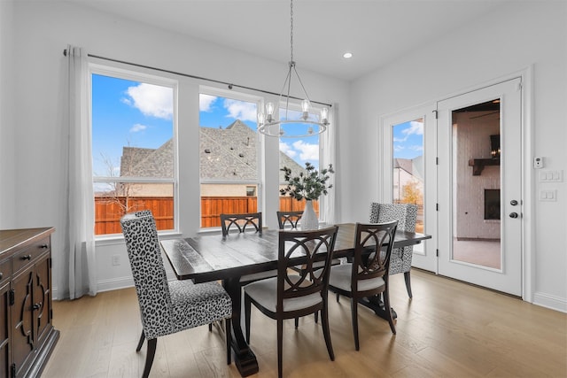 dining area featuring light hardwood / wood-style floors and a chandelier