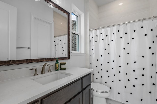 bathroom featuring vanity, toilet, and a shower with shower curtain