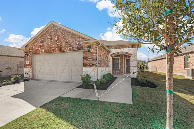 view of property featuring a garage and a front yard