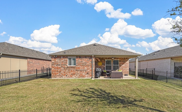 rear view of house featuring a yard and a patio