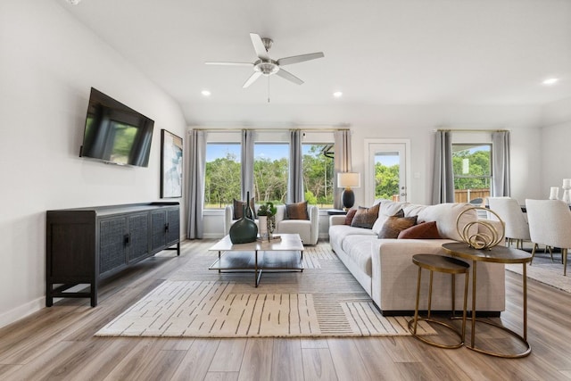 living room with light hardwood / wood-style floors and ceiling fan