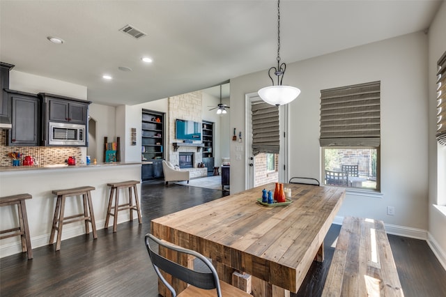 dining room with dark hardwood / wood-style floors and ceiling fan