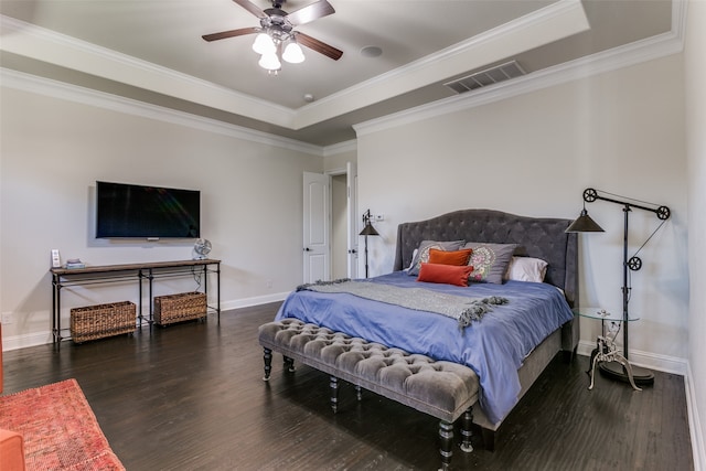 bedroom featuring dark hardwood / wood-style flooring, a tray ceiling, ceiling fan, and crown molding