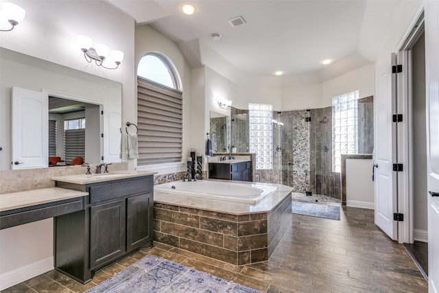 bathroom with hardwood / wood-style flooring, vanity, and independent shower and bath