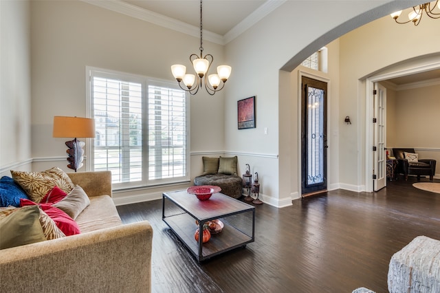 living room featuring a notable chandelier, dark hardwood / wood-style flooring, and plenty of natural light