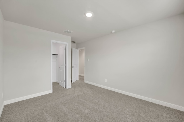 unfurnished room featuring light colored carpet