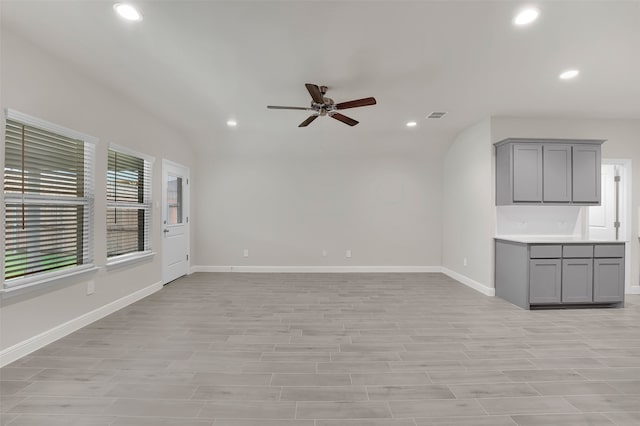 unfurnished living room with vaulted ceiling, light hardwood / wood-style flooring, and ceiling fan