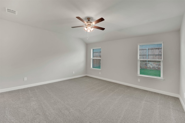 spare room featuring ceiling fan, carpet flooring, and plenty of natural light