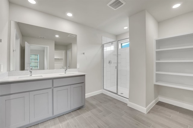 bathroom with vanity and a shower with shower door