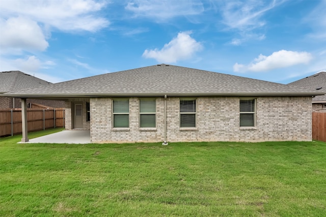 rear view of property with a patio area and a lawn