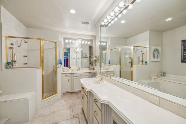 bathroom with vanity and independent shower and bath