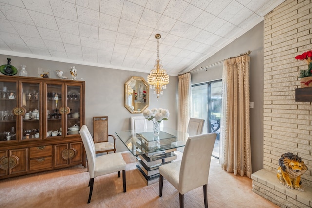 carpeted dining room featuring lofted ceiling, ornamental molding, and a chandelier