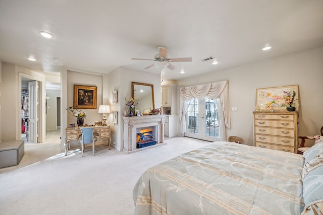 bedroom featuring french doors, access to exterior, light colored carpet, and ceiling fan