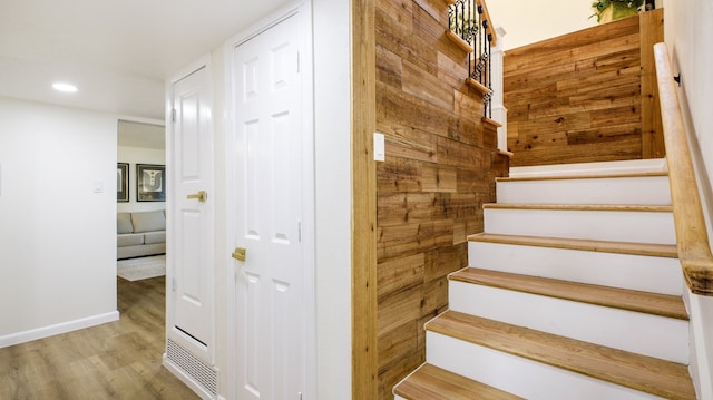 stairs featuring hardwood / wood-style floors