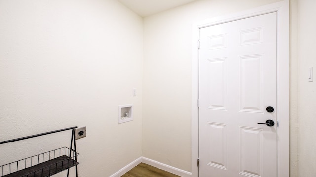 washroom with hookup for an electric dryer, hookup for a washing machine, and hardwood / wood-style flooring