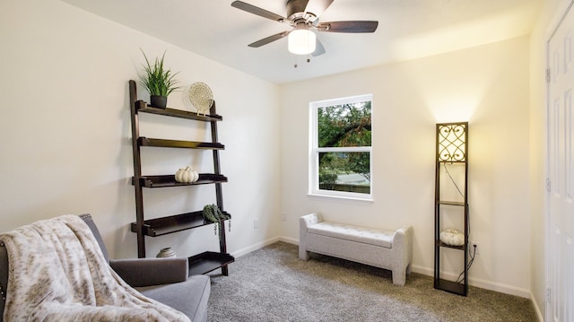 living area with light colored carpet and ceiling fan