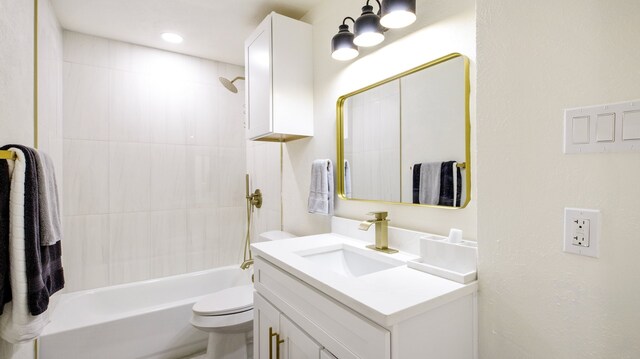 full bathroom with toilet, tiled shower / bath, and vanity