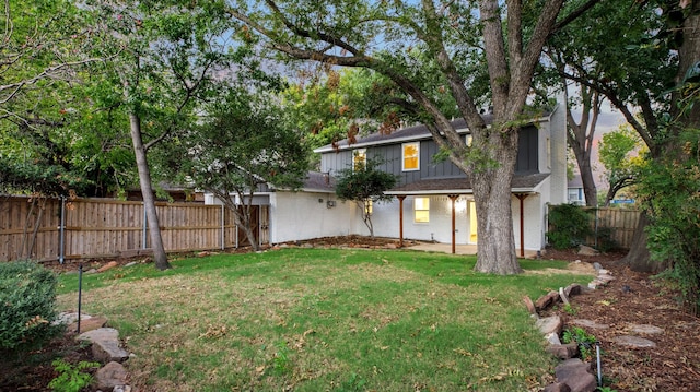 rear view of house with a yard