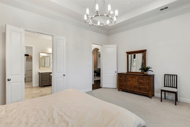 carpeted bedroom with ornamental molding, a chandelier, ensuite bathroom, and a raised ceiling