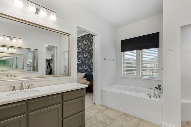 bathroom featuring vanity, tiled bath, and tile patterned floors