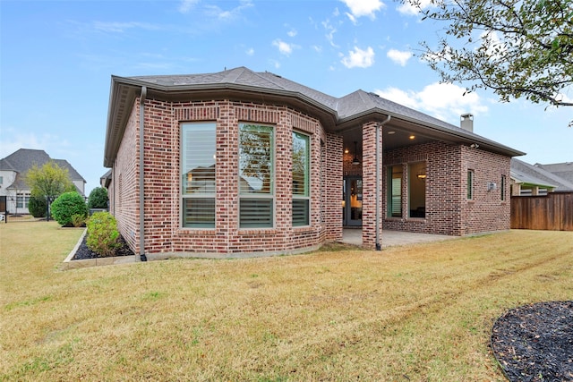 rear view of property with a yard