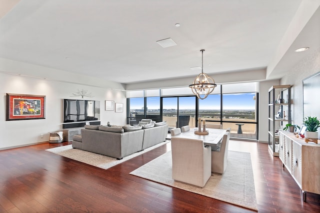 living room featuring a chandelier and dark hardwood / wood-style flooring