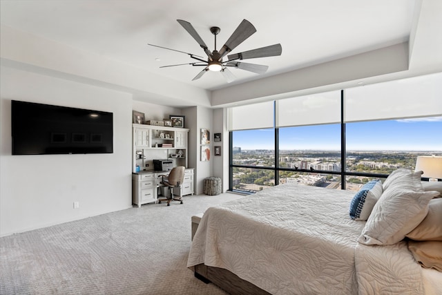 carpeted bedroom featuring multiple windows and ceiling fan