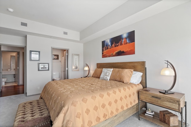 carpeted bedroom with ensuite bathroom