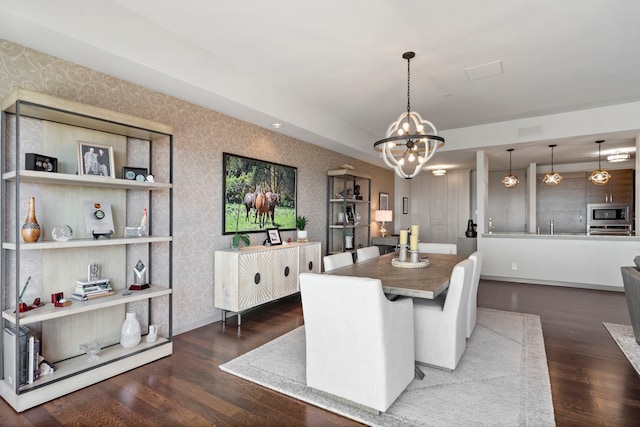 dining room featuring a notable chandelier and dark wood-type flooring