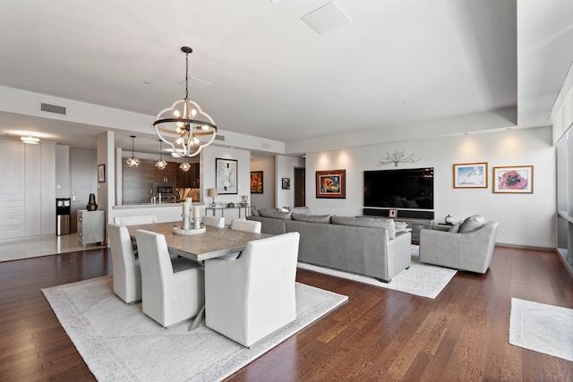 dining area featuring a notable chandelier and dark hardwood / wood-style flooring