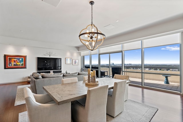 dining space featuring a notable chandelier and hardwood / wood-style flooring