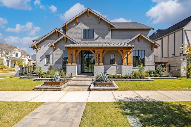 view of front of property with a porch and a front yard