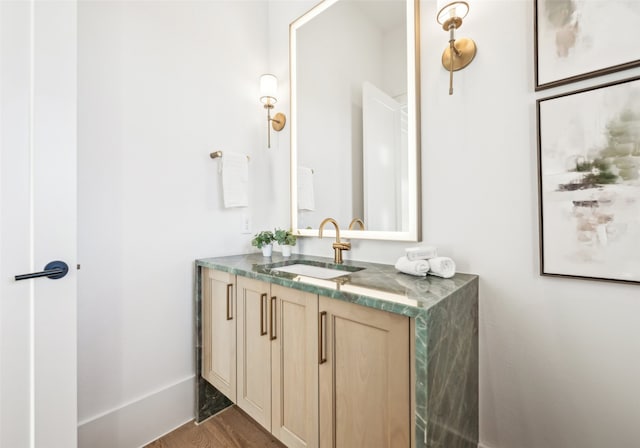 bathroom with vanity and wood-type flooring